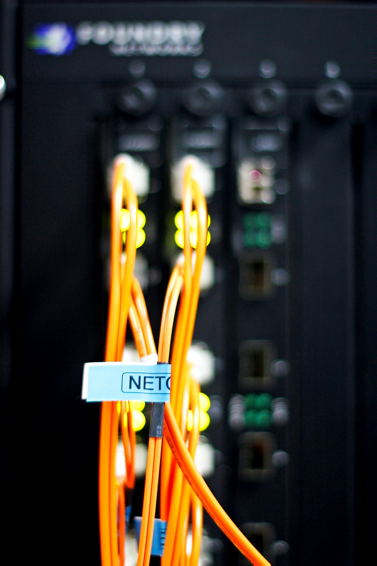 Network infrastructure cabling with blue and magenta lighting